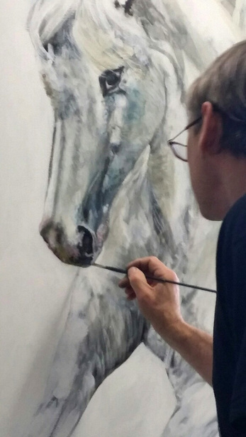 David J Rau at work in his studio painting horses